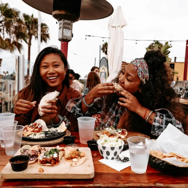 two young women enjoy authentic tacos in the Gaslamp Quarter